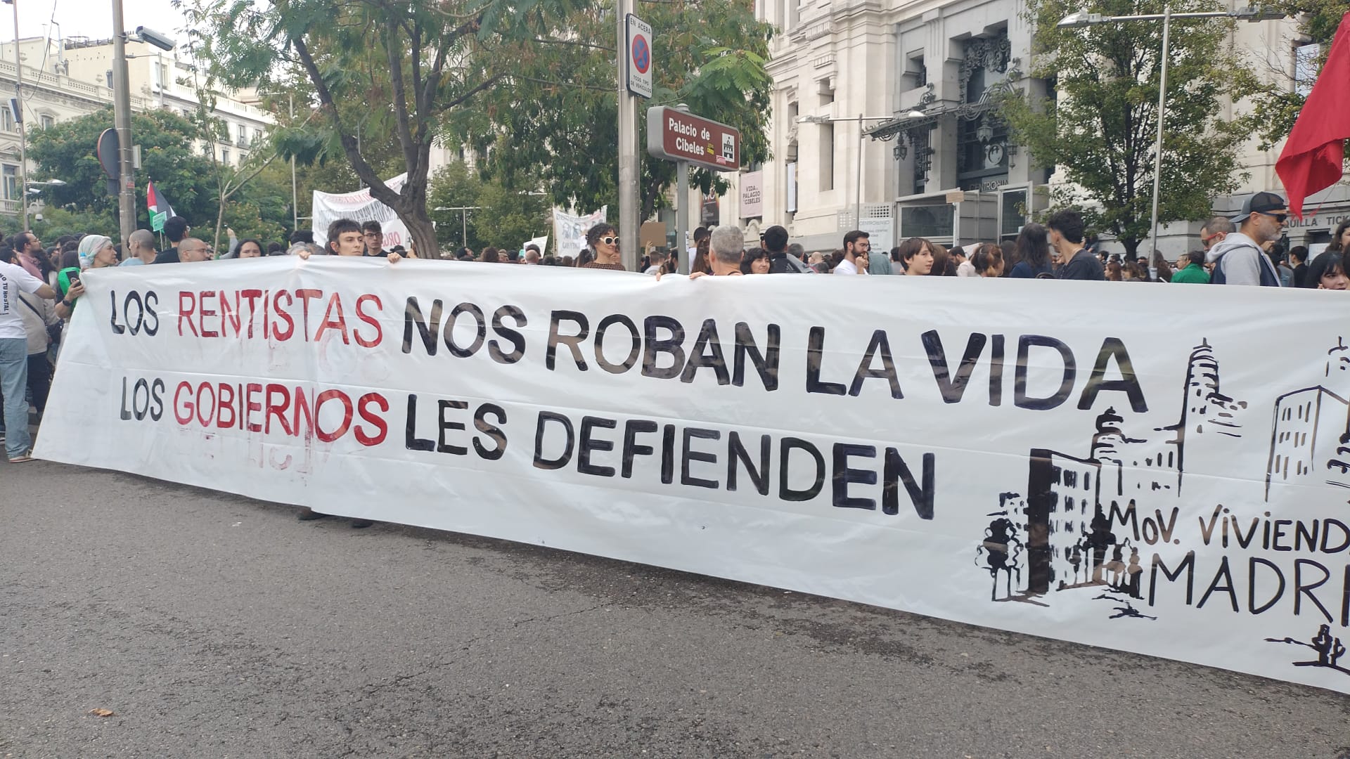 Banner reading "The renters robs us of our lives, the government defends them"