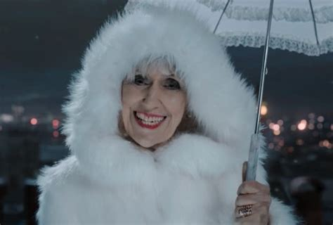 Mrs. Flood from "Empire of Death", wearing a white fur coat.